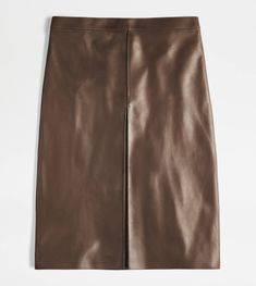 A refined artisanal taste characterizes this skirt crafted in soft nappa leather with semi-matte finishing. An essential garment Characterized by a front pleat and back vent, it comes with zip fastening. Elegant Leather Bottoms For Office, Sleek Brown Leather Bottoms, Formal Brown Leather Skirt, Leather Midi Skirt With Lining, Leather Lined Midi Skirt, Spring Brown Leather Skirt, Brown Leather Skirt For Spring, Elegant Brown Leather Skirt, Elegant Brown Leather Bottoms