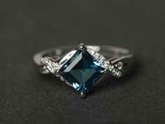 Welcome to my shop, you can find many beautiful gemstone jewelry here, and you also can ask for customized service. Main Stone: London blue topaz, square cut 7X7mm, about 2.30 carats Accent Stones: cz Metal: 925 sterling silver plated with rhodium. I also can provide metal options such as 14k solid yellow/white/rose gold Setting: prong setting More rings: https://www.etsy.com/shop/XCjewelryStudio?ref=hdr_shop_menu It's a perfect gift for the person who was born in November (Birthstone), it's qui London Topaz Ring, Topaz Wedding Ring, Heart Shaped Engagement Rings, Blue Gemstone Ring, Blue Engagement Ring, Blue Topaz Engagement Ring, Ring Square, Blue Gemstone Rings, Sparkly Ring