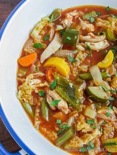 a white bowl filled with chicken and vegetable soup