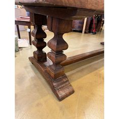 an old wooden table is being displayed in a store