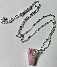 Cocktail Necklace    Colourful acrylic cocktail glass charm with straw on a silver metal chain.  1.4cm wide by 2.5cm tall by 1.3cm thick.  50cm long chain average with extension chain to 54cm long approximately. (Handmade item, sizes may change). Brand new, handmade item in it's original packaging.  Age 3+. Up Cosplay, Cocktail Necklace, Cocktail Glass, Colourful Necklace, Stocking Filler, Stocking Fillers, Long Chain, Age 3, Beach Dress