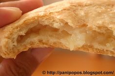 a close up of a person holding a piece of food in their hand with the other hand