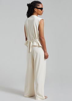 Color: Cream Midweight cotton blend fabric Relaxed fit Sleeveless Adjustable back buckle Front breast illusion welt pocket Asymmetrical hem Asymmetrical snap button closure Lined 50% Bamboo Cotton 48% Polyester 2% Elastane Dry Clean By The Frankie Shop. Imported