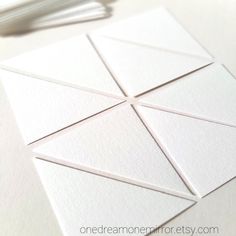 some white cards are laying on a table