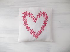 a cross stitch heart on a white background