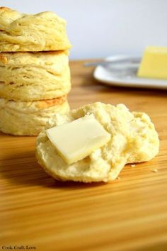 some biscuits and butter on a wooden table