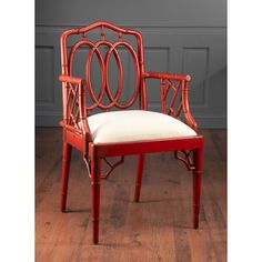 a red chair sitting on top of a hard wood floor