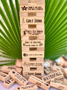 a stack of wooden blocks sitting on top of a table next to a palm tree