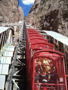 several cages are lined up on the side of a mountain