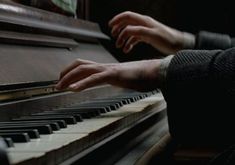 someone is playing the piano with their hands