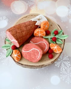 an arrangement of fruit and pastry on a wooden platter with snowflakes in the background