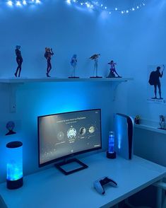 a desktop computer sitting on top of a white desk next to a blue light filled wall