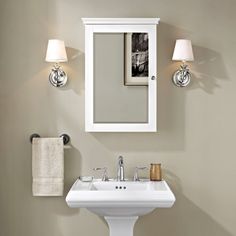 a bathroom sink sitting under a mirror next to a wall mounted cabinet with lights on it