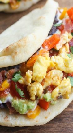 two tortillas filled with scrambled eggs and vegetables