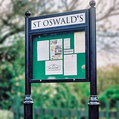 there is a sign that has been placed in front of a fenced area with trees