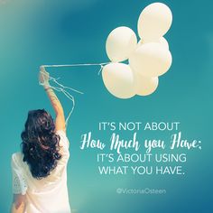 a woman flying a bunch of white balloons in the sky with a quote on it