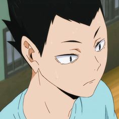 an anime character with black hair and blue shirt looking at the camera while staring into the distance