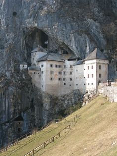 an old castle built into the side of a mountain