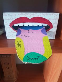 a cardboard box that has a mouth and tongue on it with the words sweet inside