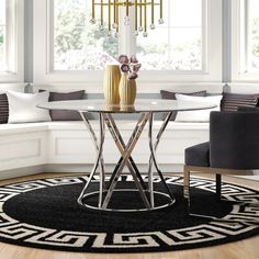 a living room with a couch, chair and table in it's centerpiece