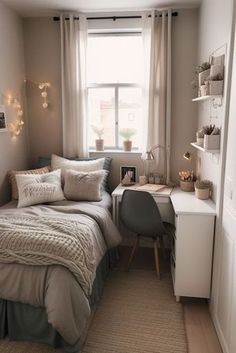 a small bedroom with a bed, desk and window in the corner that is lit by string lights