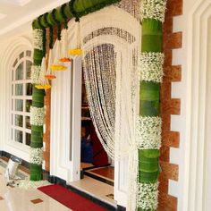 an entrance decorated with white flowers and greenery