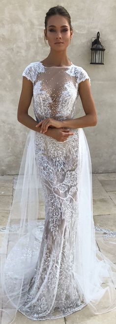 a woman in a white wedding dress with a veil on her head