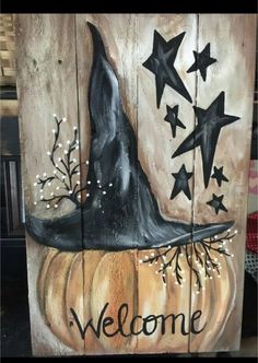 a wooden sign with a witches hat and stars on it