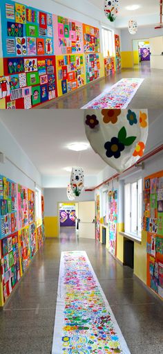 the hallway is decorated with colorful paintings and paper machs hanging from the ceiling above