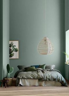 a bedroom with green walls and wooden floors is featured in the instagram post on instagram