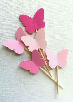 pink and red paper butterflies on sticks with toothpicks in the shape of hearts