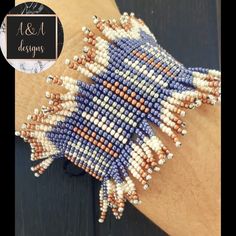 a hand made beaded bracelet with white and blue beads