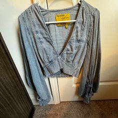 Never Worn Super Comfortable Fit Trendy Light Wash Denim Blouse, Spring V-neck Denim Top, Trendy Washed Blue Denim Blouse, Long Sleeve Denim Top With Ruffles, Trendy Denim Tops With Ruffles, Long Sleeve Denim Blue Top With Ruffles, Blue Long Sleeve Denim Top With Ruffles, Blue Ruffled Long Sleeve Denim Top, Spring Denim Blue V-neck Top