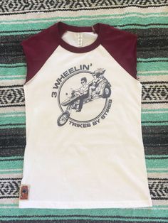 "We replicated this super soft baseball tee from one of our favorite 1970s vintage shirts. Great for guys or gals! Sizing is equivalent to a unisex t-shirt. A women's Small is like an XS in this shirt. Choose black or maroon sleeves. This listing is for the sleeveless tee. We crop the sleeves and they roll slightly for that super 80s vintage look. Message us if you want to leave the sleeves uncropped (they will be 3/4 length) or see our other listings for this variation. AVAILABLE SIZES (measure Biker T Shirts, Quote Tees, Sleeveless Tee, Retro 70s, 80s Vintage, Inspiration Mode, Mode Inspiration, Favorite Shirts, Vintage Look