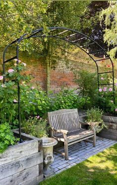 a wooden bench sitting in the middle of a garden