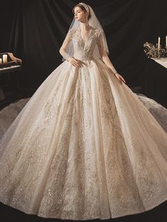 a woman in a wedding dress standing next to a piano