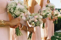 the bridesmaids are holding their bouquets in each hand and wearing pink dresses