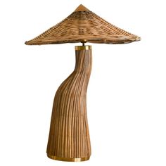 a table lamp made out of wicker with a wooden shade on the top and bottom