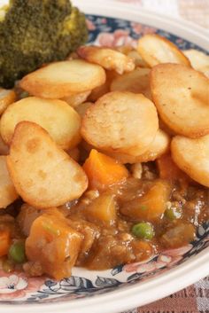 a plate full of food with potatoes, broccoli and meat on the side