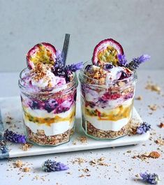 two desserts with fruit and granola in glass jars