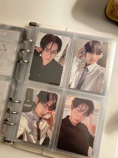 an open book with four photos of young men in ties and glasses on the pages