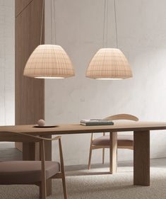 two lamps hanging over a wooden table in a room with white walls and beige carpet