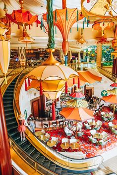 the inside of a restaurant with tables and umbrellas