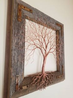 a wooden frame with a tree cut out of it's branches on the wall