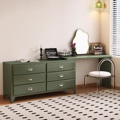 a green dresser sitting next to a white chair