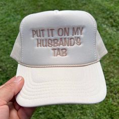 This beautifully crafted hat is great for any occasion. "PUT IT ON MY HUSBAND'S TAB" is embroidered on a high-quality OTTO high-profile 5-panel foam hat. You can customize this hat the way you want by picking your favorite hat and thread color.  How to order. 1. Pick your hat color. 2. Pick your thread color. 3. Add it to your cart.  If you have any questions, please message me before ordering, I will be happy to help you. Hat Description The Traditional Look 5-panel cap Seamless Foam Front Pane Groom Hat, Wedding Funny, Hat Wedding, Trendy Hat, Funny Hats, Embroidered Hat, Sarasota Fl, Embroidered Hats, Color 2