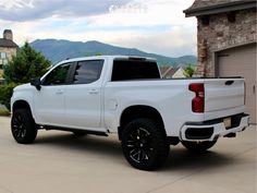 a white truck parked in front of a house