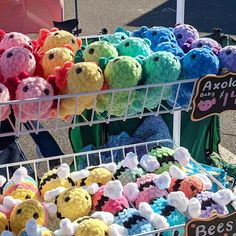 there are many stuffed animals on display at this street vendor's booth for sale