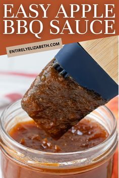 an apple bbq sauce in a glass jar with a wooden spoon sticking out of it