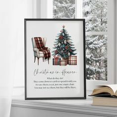 a christmas tree and plaid chair in front of a window with a book on the windowsill